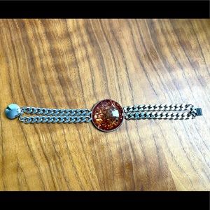 Chain bracelet with amber colored stone